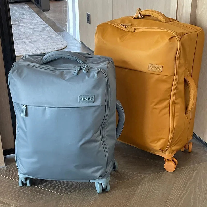 Ultra-light waterproof Oxford cloth suitcase in bluestone green with universal wheels.