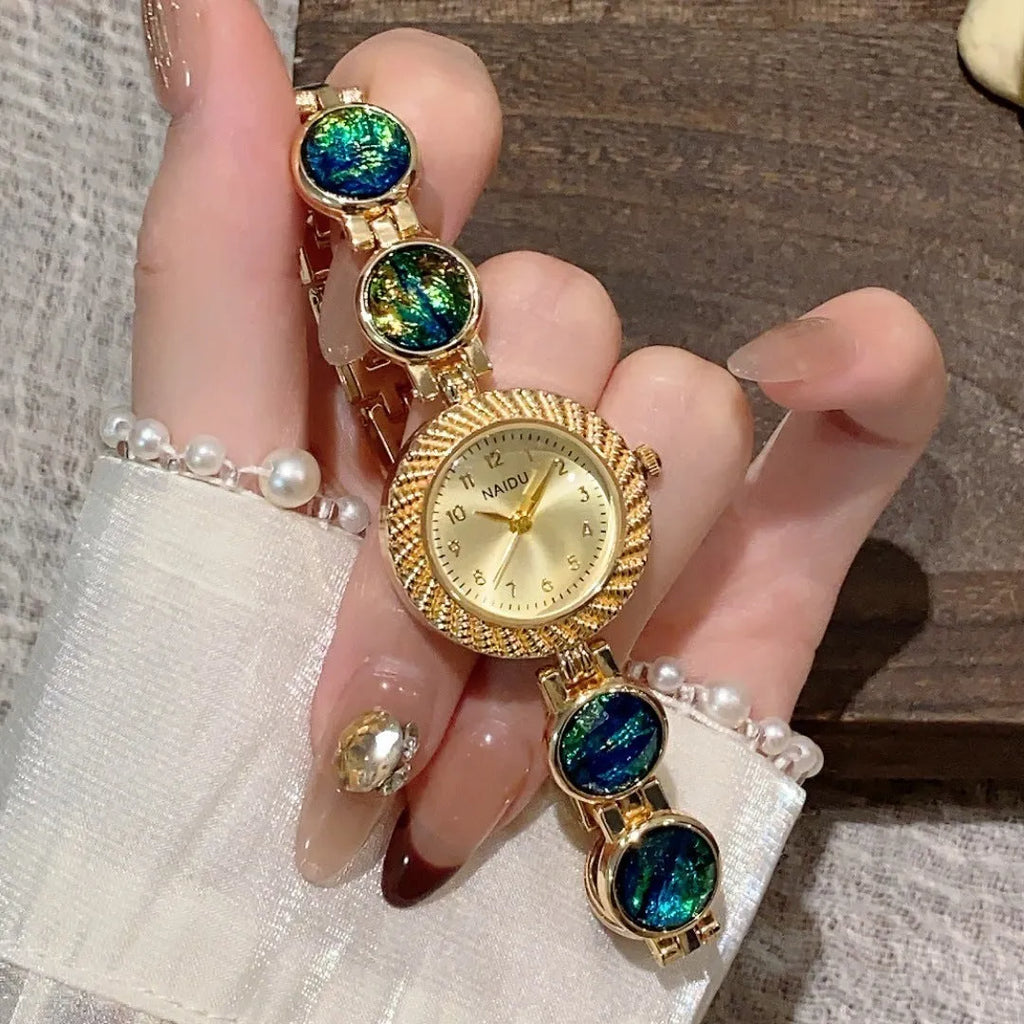 Women's quartz watch with 25mm round dial in zinc alloy case, shown in multiple colours.