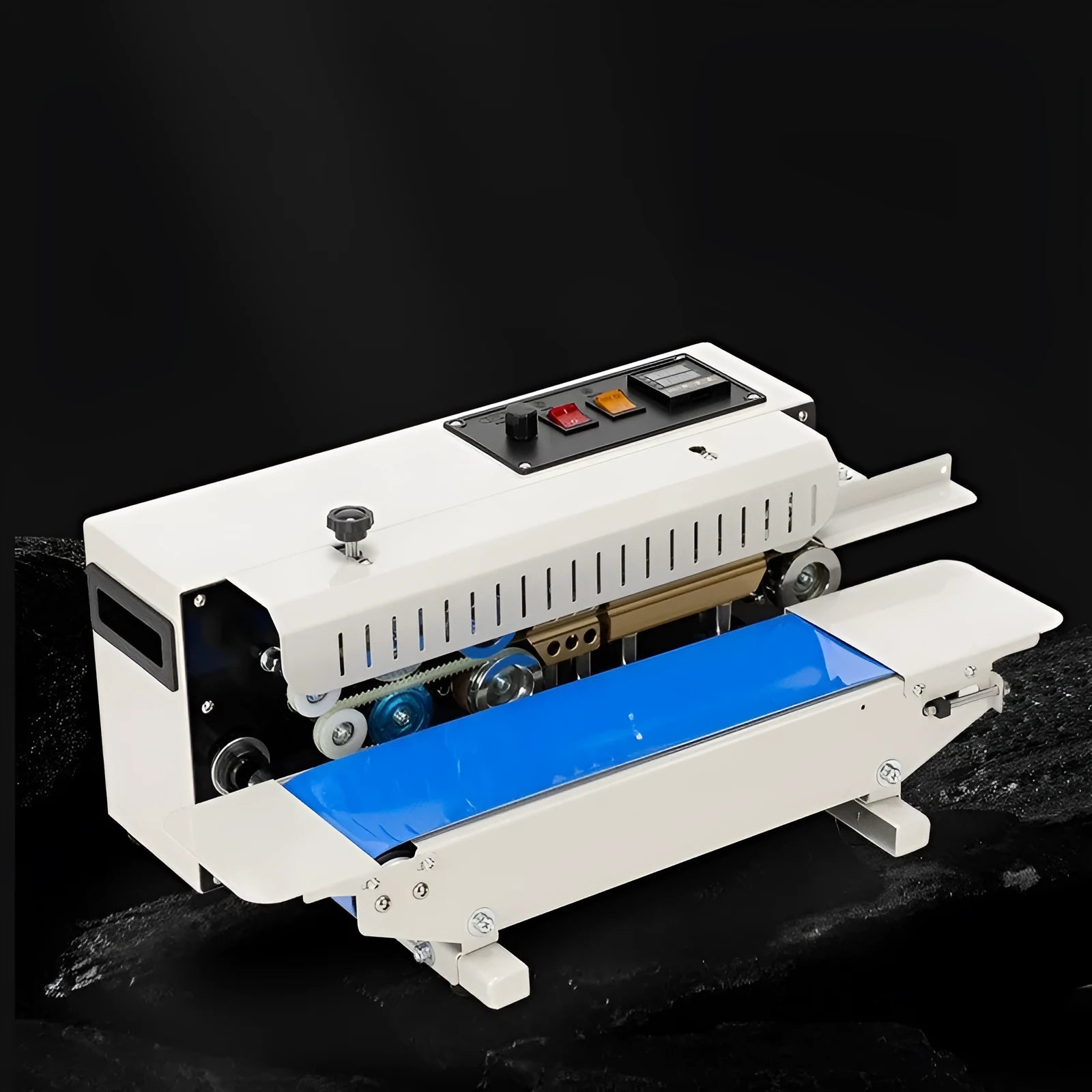 Compact manual sealing machine with date stamp on steel head, placed on a kitchen worktop.