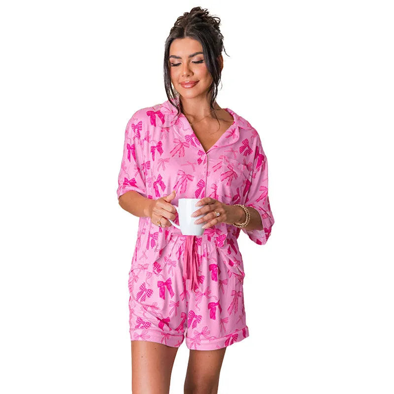 Pink bow print two-piece polyester pajama set for sleep and home wear.