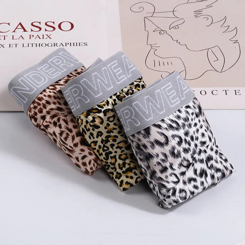 Men's loose fit leopard print underwear in milk silk polyester fabric showing mid-waist design