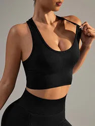 Black women's sports bra with cross-back design and moulded cups for yoga and running.