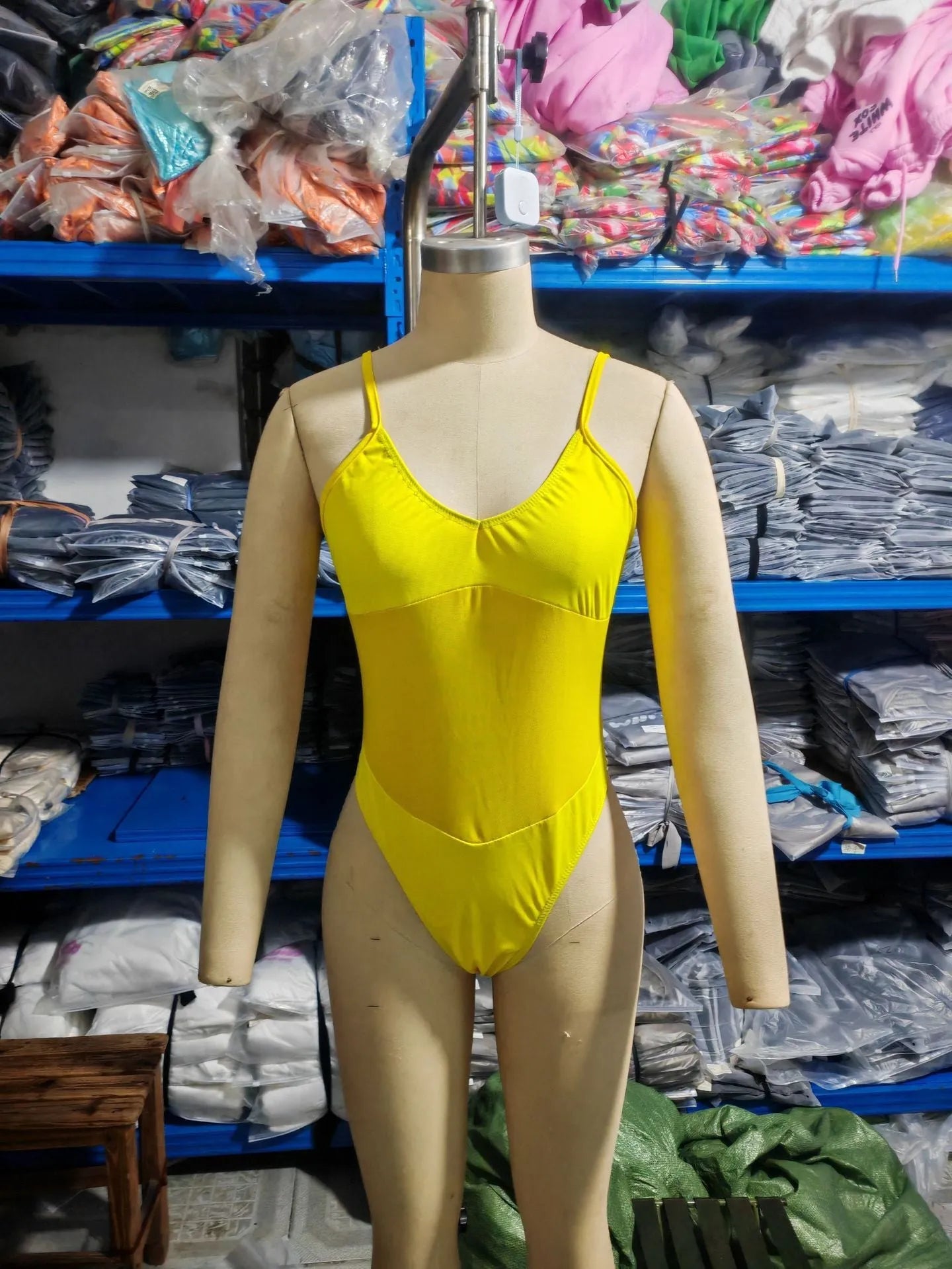 Black banded bikini style one-piece swimsuit with sleeveless design and solid colour finish