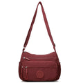 Water-repellent nylon crossbody bag with three-dimensional pocket shown in grey colour