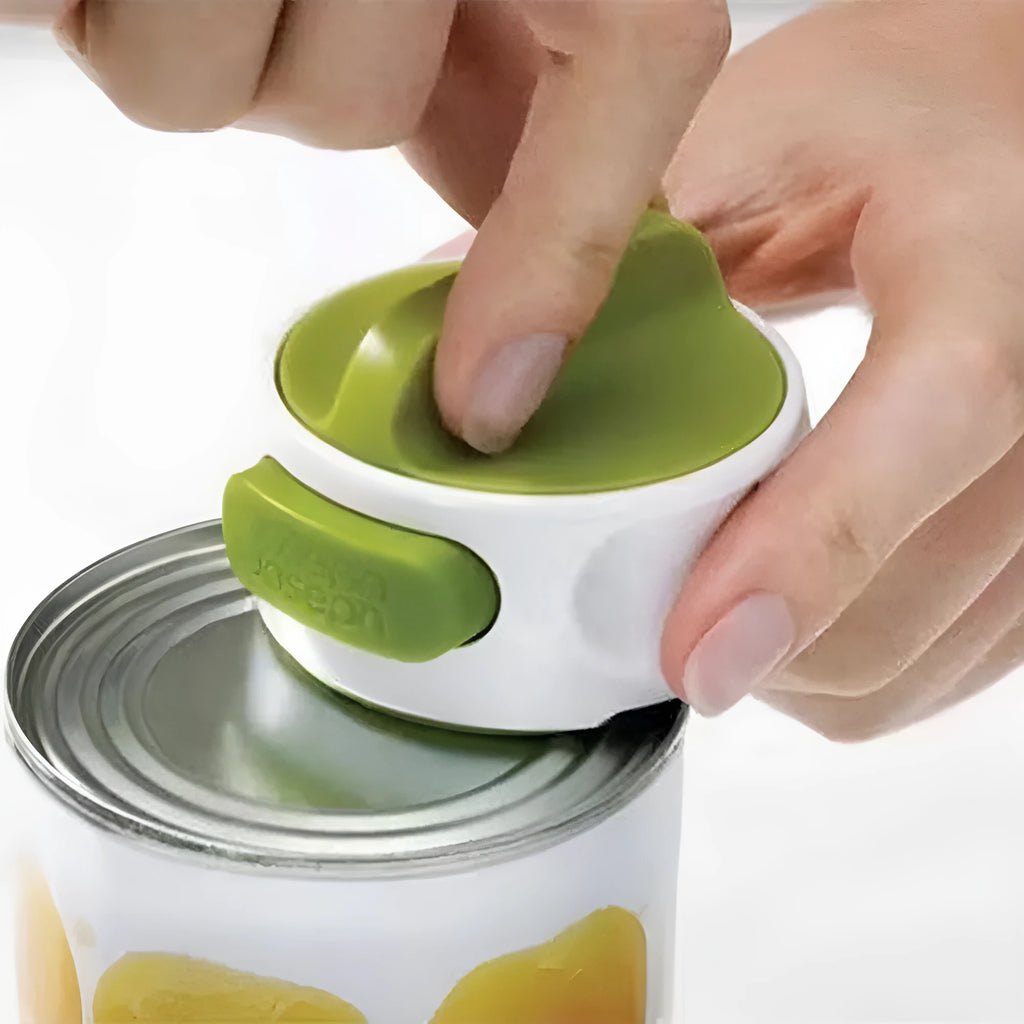 A green stainless steel manual bottle opener and lid removal tool on a kitchen counter.