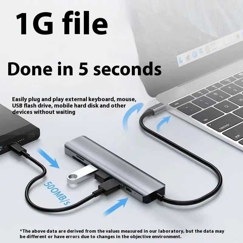 Silver USB Type-C 7-in-1 expansion dock with HDMI port and 15cm attached cable on a desk.