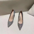 Women's silver and black bridal stiletto shoes with PU leather construction on a white background.