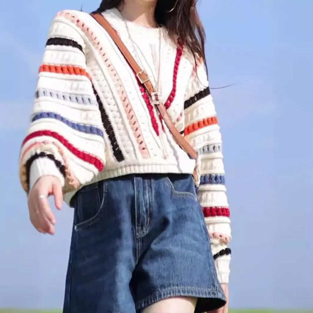 Multicolour rainbow striped women's sweater with batwing sleeves and a loose round neck fit.