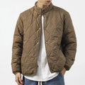Men's black diamond lattice quilted winter jacket with extended length and loose fit.