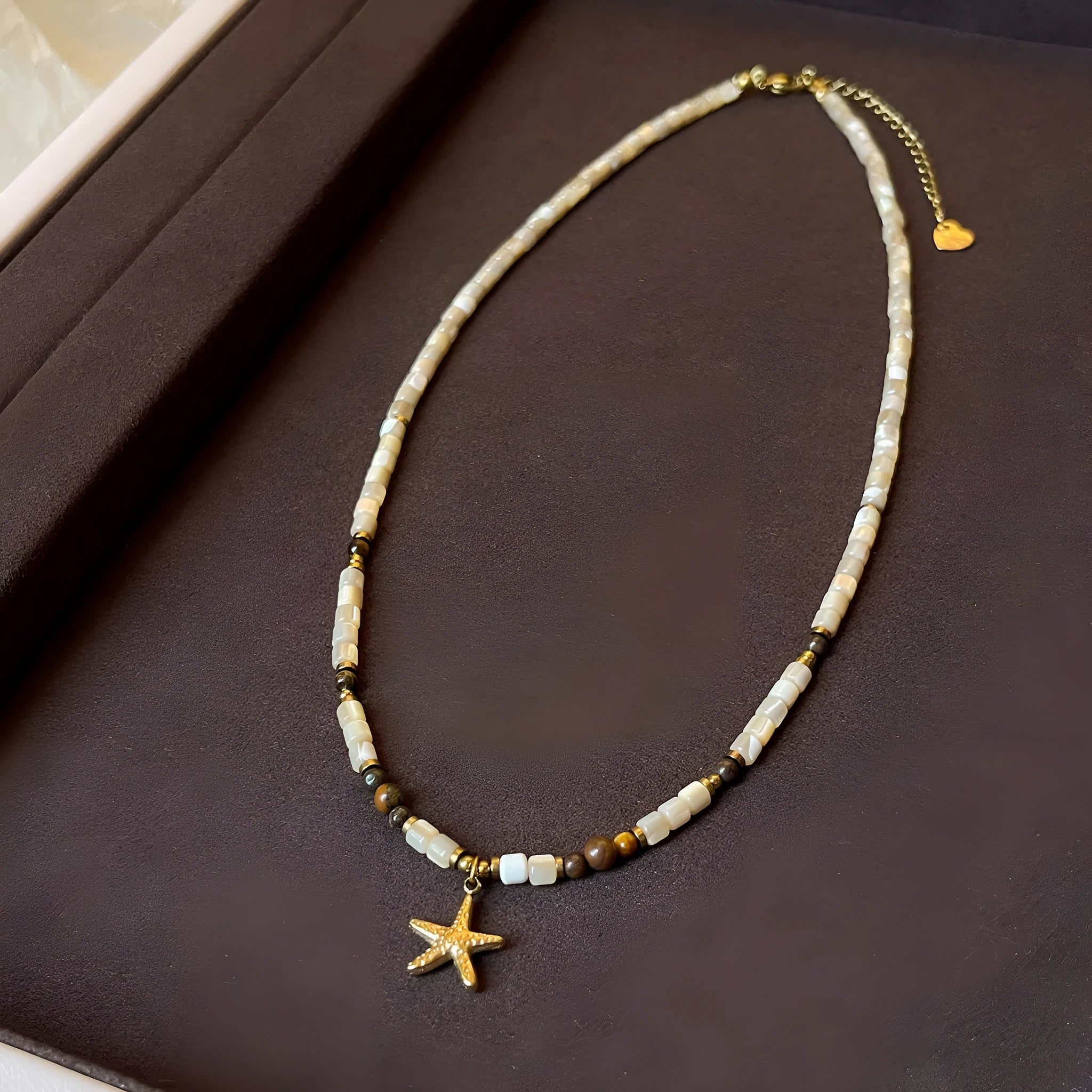 Titanium steel starfish pendant necklace with natural shell and tigereye on a beaded Maillard style chain