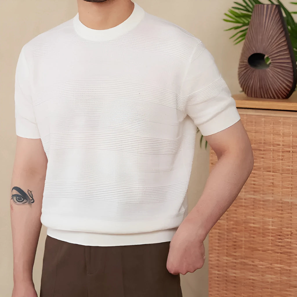 Men's off-white pure cotton short sleeve t-shirt with a round neck, laid flat on a surface.