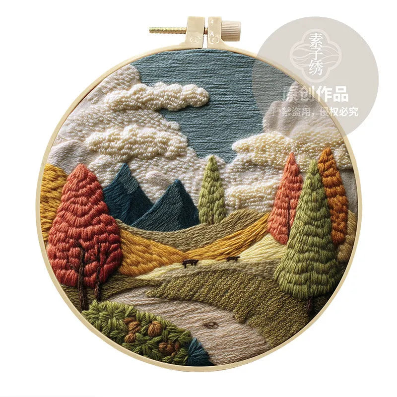 Embroidery DIY kit with landscape designs on cotton fabric, bamboo frame, thread, and needles