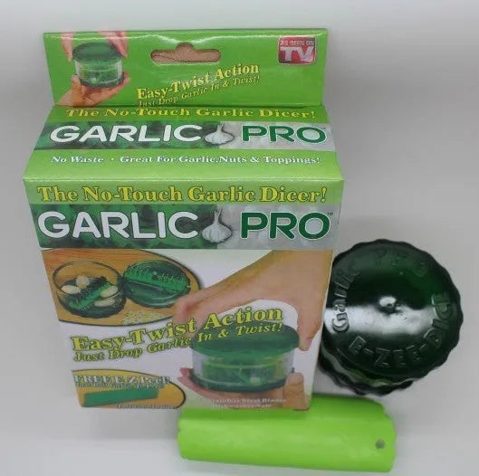 Green transparent plastic garlic peeler kitchen gadget on a counter.