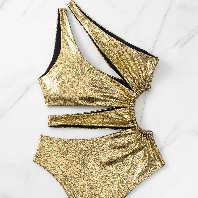 Gold women's one-piece swimsuit with backless design and spandex construction