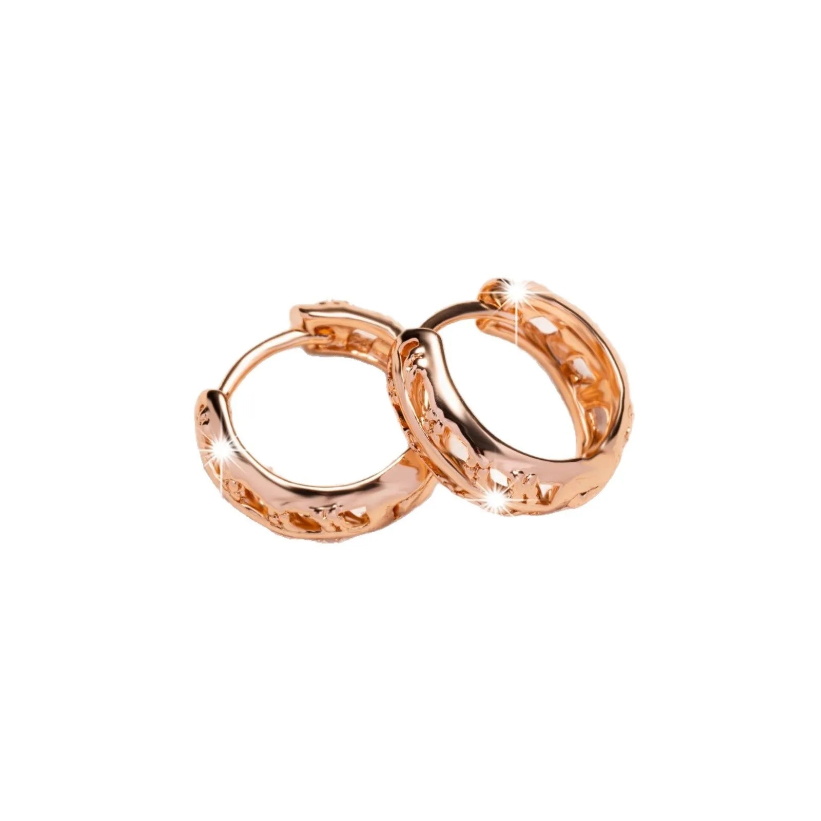 Rose gold hollowed-out heart and leaf shaped copper earrings on a white background, showing intricate cut-out details.