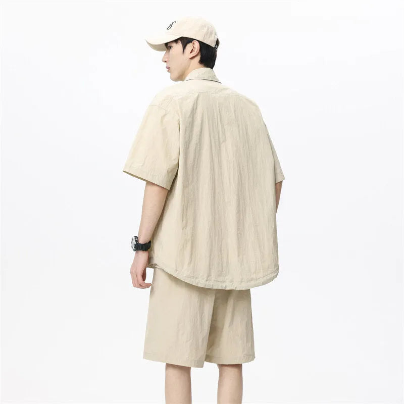 Men's loose casual shirt and matching shorts two-piece set in a light grey colour.