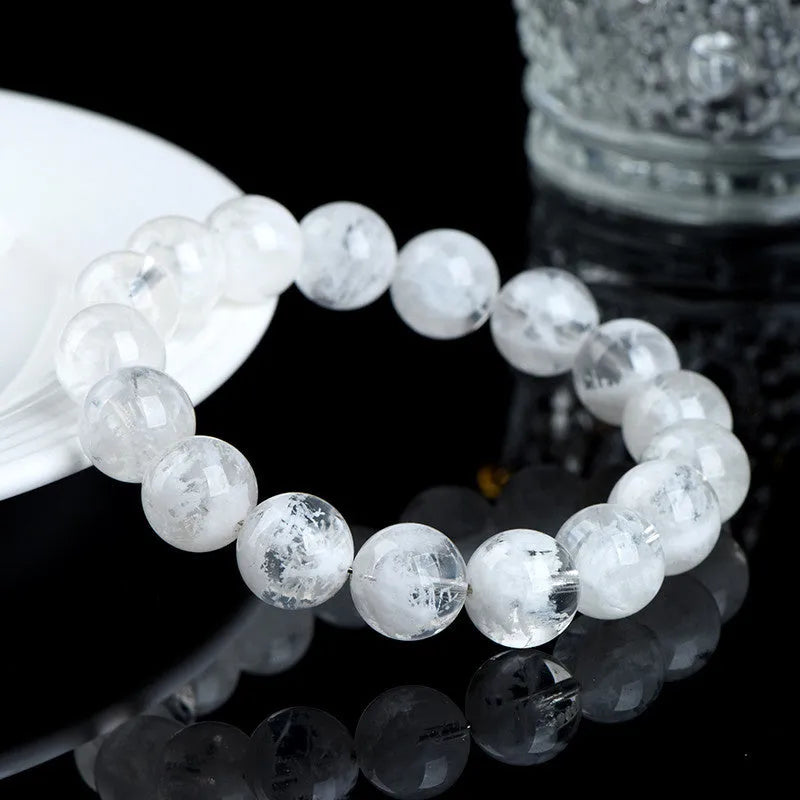 Women's crystal bracelet with round blizzard snowflake beads and traditional Ruyi and Xiangyun symbols.