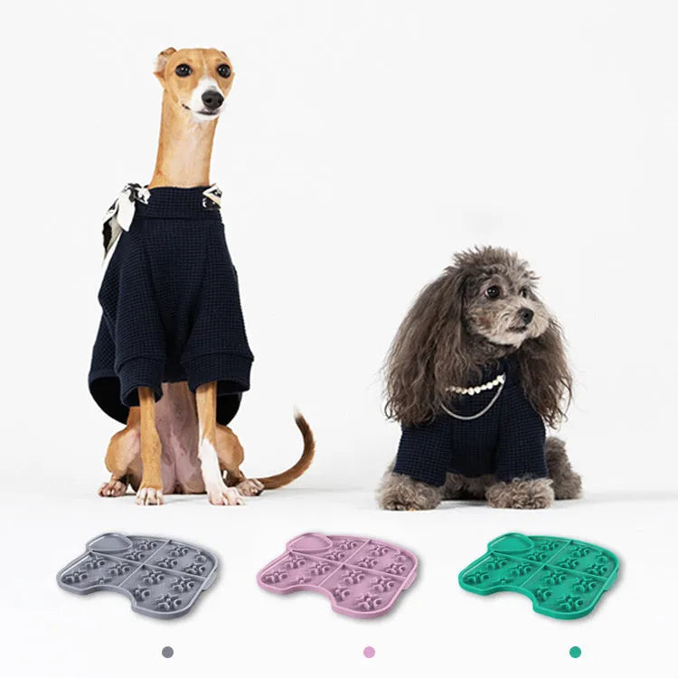 Gray silicone pet slow food pad with suction cups on tile floor, textured surface for licking