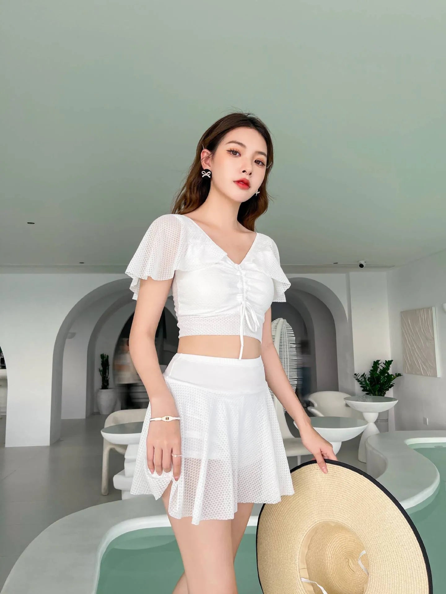 Women's solid colour two-piece swimsuit with a separate top and skirt.