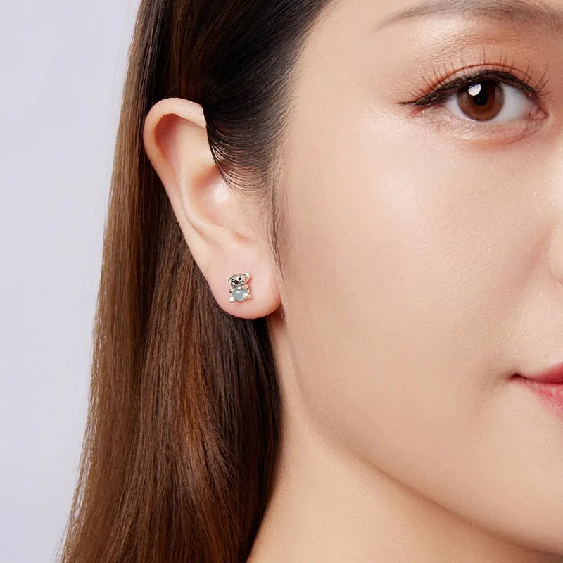 S925 sterling silver dangling koala bear earrings with dripping oil finish on a white background