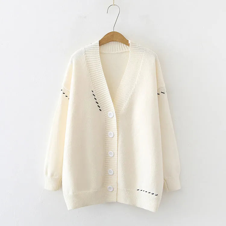 Women's loose black knitted cardigan coat with long sleeves.
