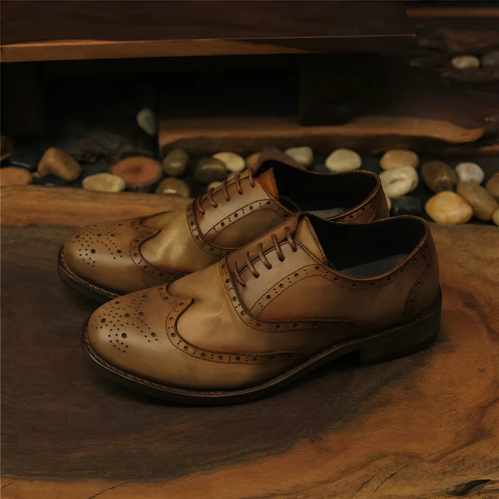 Light brown men's distressed leather lace-up shoes with engraved detailing and round toe on a neutral background.