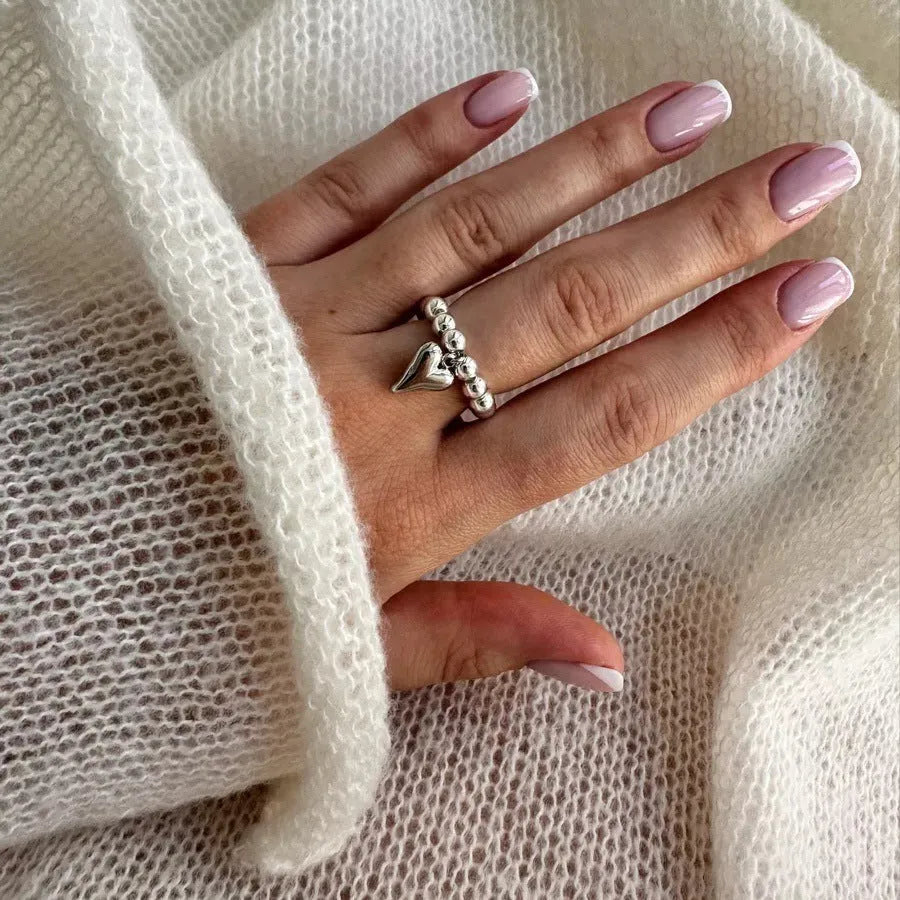 Handmade beaded elastic string love ring with geometric heart design in electroplated colours