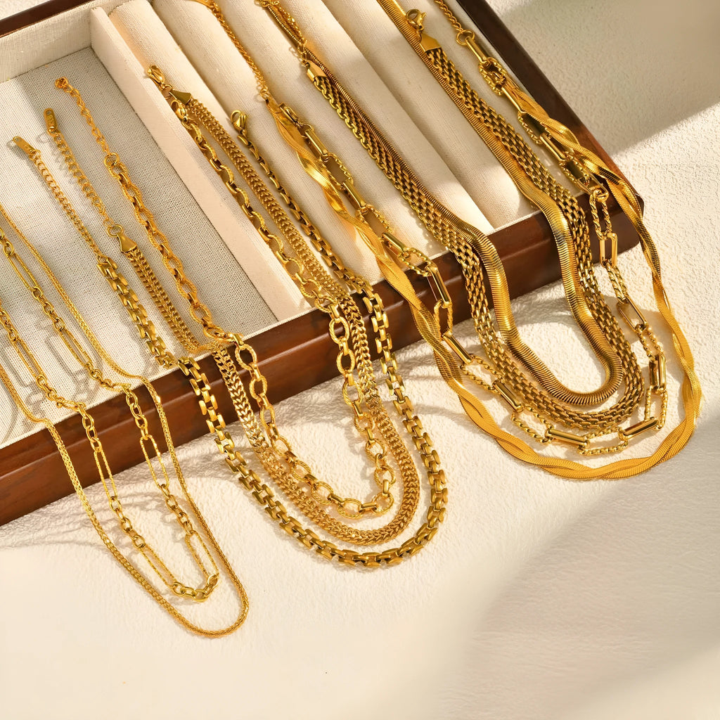 Stainless steel geometric twist necklace on snake bones chain, available in multiple colours