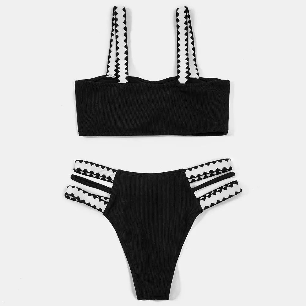 Black women's hollowed-out split swimsuit bikini on a neutral background