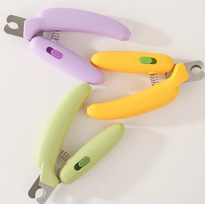 Banana-shaped pet nail clippers in green with metal blades for dog and cat grooming