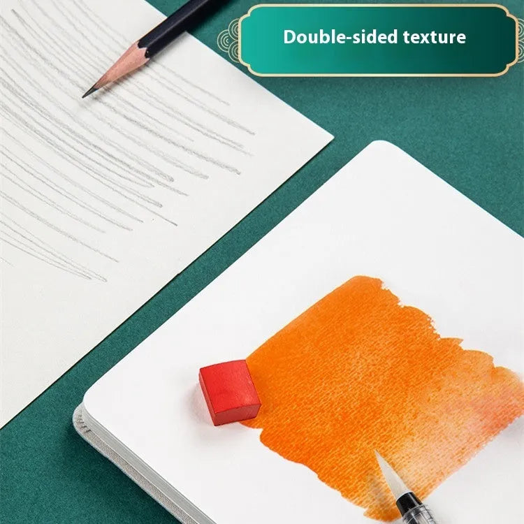Feiluniao handmade fabric watercolour notebook open showing a painted sketch, with pine green cover.