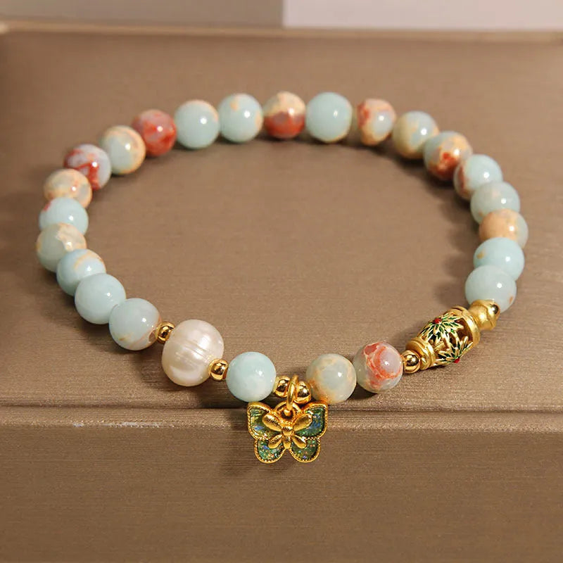 Blue freshwater pearl bracelet with Shoushan stone accents and detailed butterfly pendant