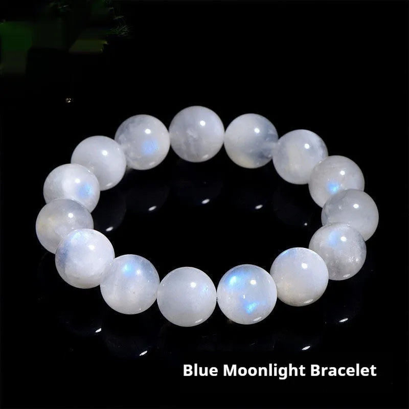 Natural white moonstone bracelet with round polished beads showing a blue sheen, laid flat.