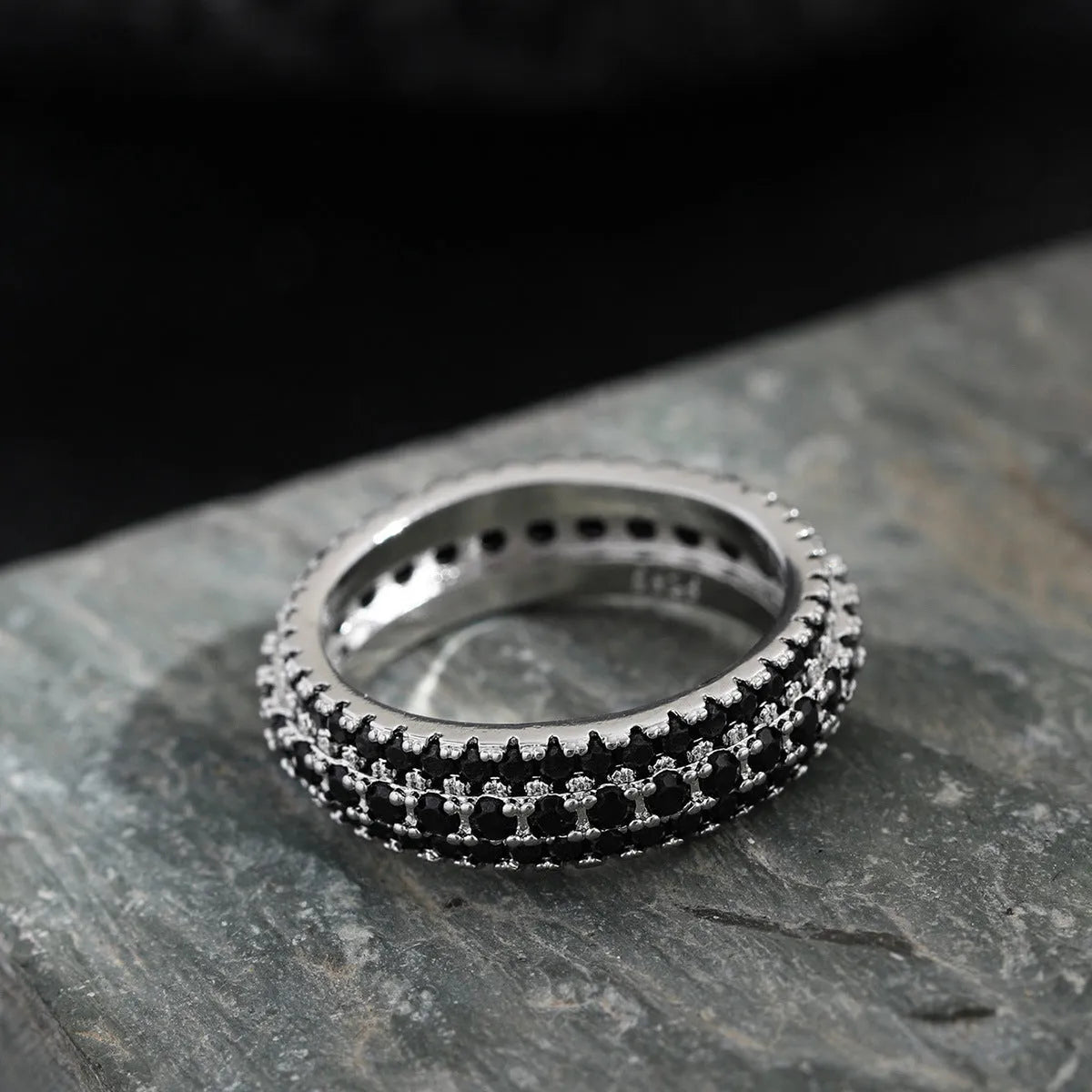 Geometric copper ring with a triangular zircon stone inlay, shown in a choice of colour finishes.