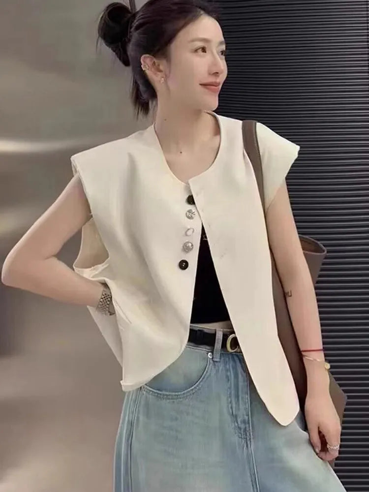 Women's loose fit polyester vest in milky white with pockets, shown on a hanger.