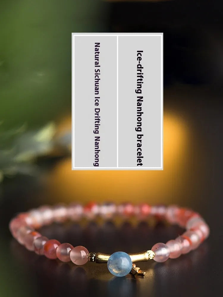 Polished Nanhong Agate flower bracelet with bamboo joint design on wrist.