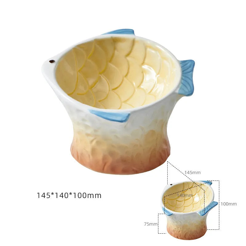Blue ceramic fish-shaped cat bowl with tilted design and non-slip base on a wooden surface