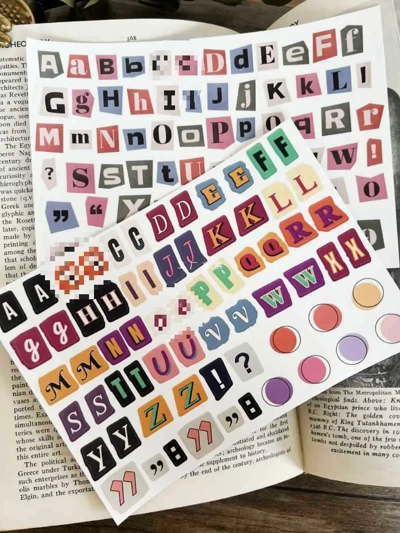 Pack of printed decorative stickers showing English letters, numbers, symbols, and weekly words in a cute style.