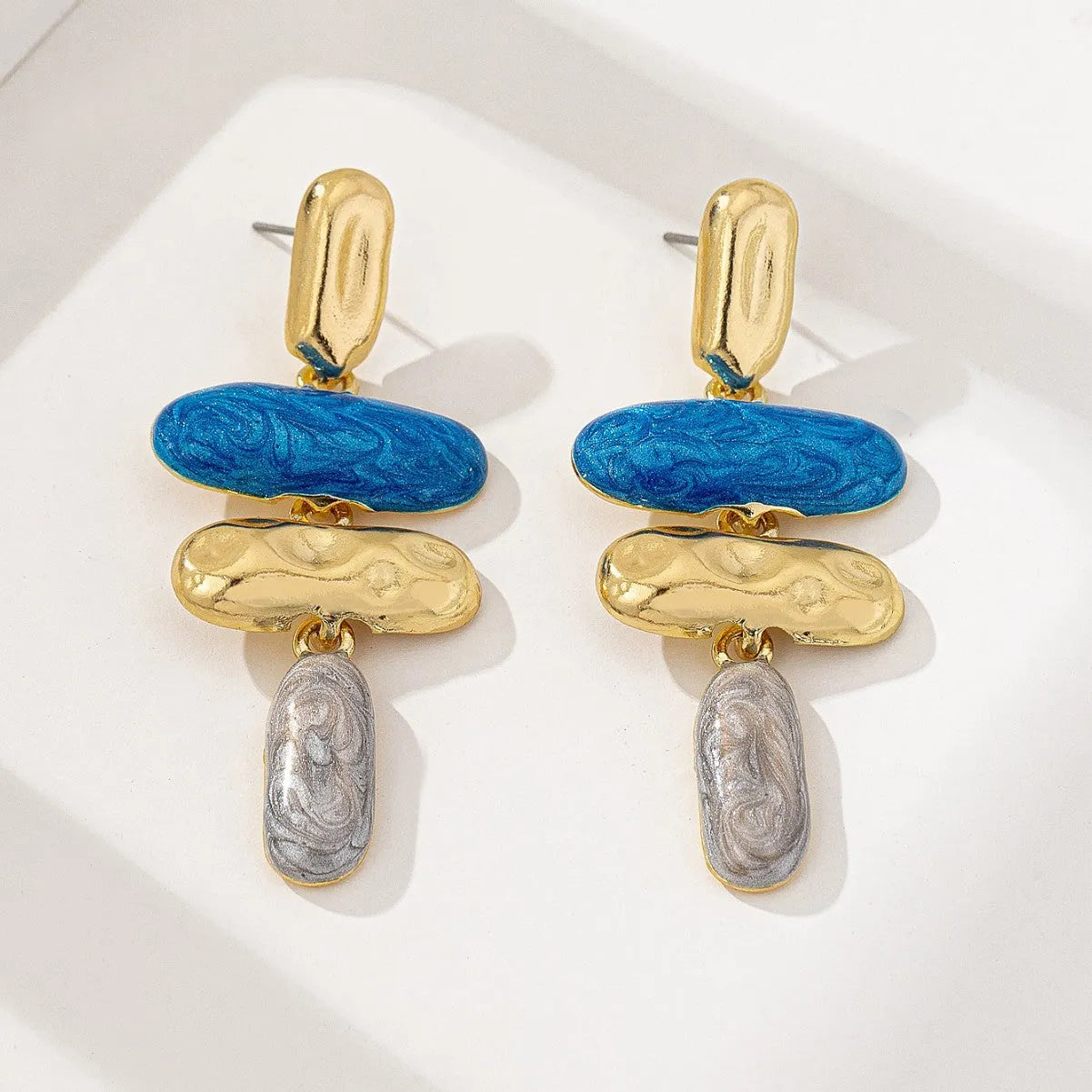 A pair of women's geometric stud earrings with a multicolour electroplated finish on zinc alloy.