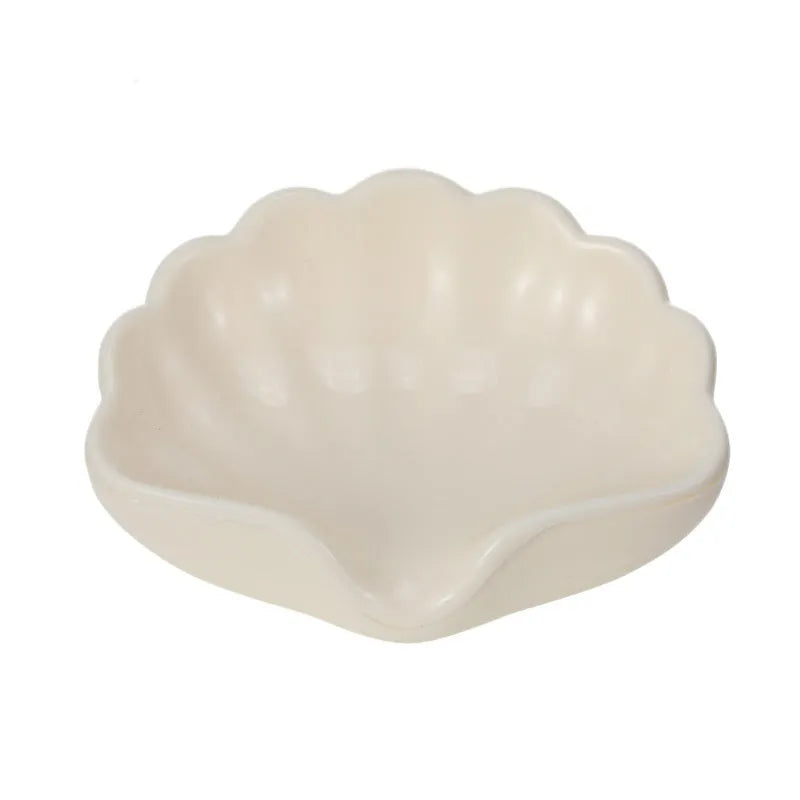 White plastic shell-shaped soap dish for bathroom countertop