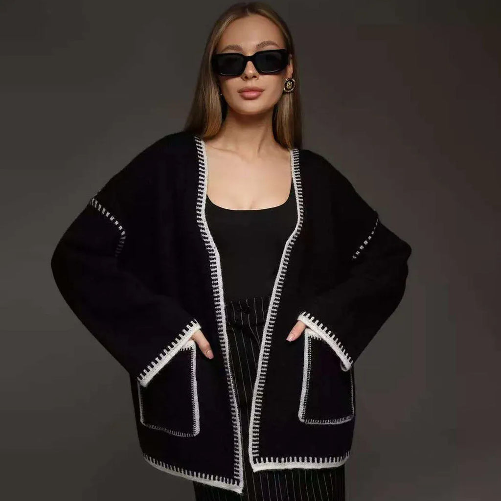 Loose fit lace-up knitted cardigan in black, shown as a mid-length sweater coat.