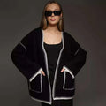 Loose fit lace-up knitted cardigan in black, shown as a mid-length sweater coat.