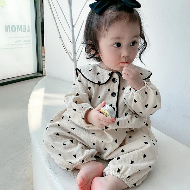 Baby onesie autumn corduroy long sleeve neutral gender beige infant bodysuit on white background