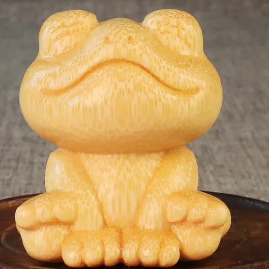 Solid bamboo carving ornament of a smiling frog, 5cm high, cute cartoon style.