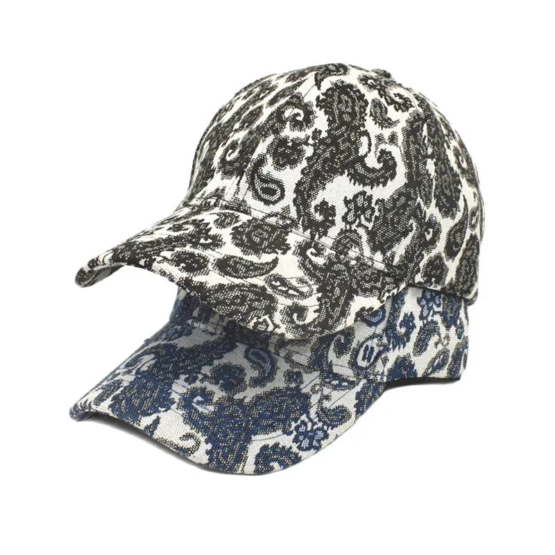 Blue paisley print polyester baseball cap with a dome crown, shown from the side.