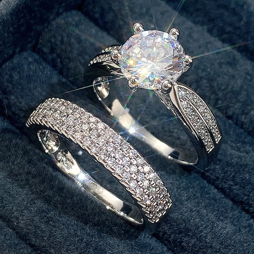 White gold alloy combined ring bracelet with round geometry design on finger.