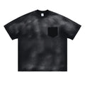 Black loose-fit men's cotton t-shirt with drop-shoulder sleeves on a grey background.
