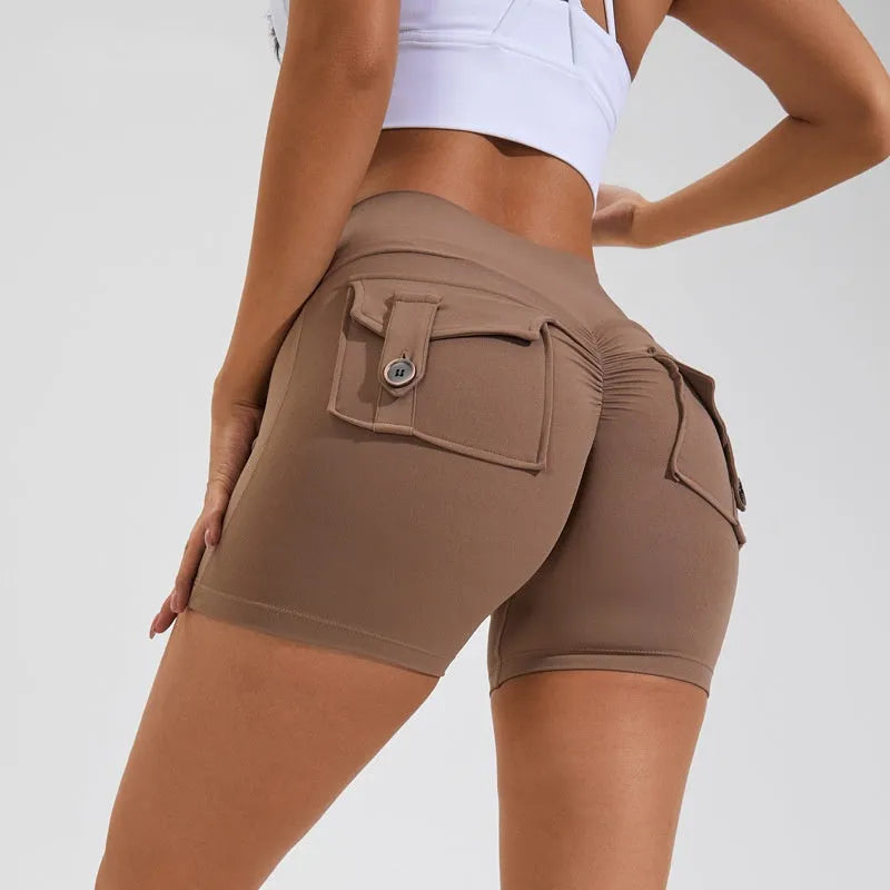 Women's high waist hip lifting fitness shorts in a solid colour with side pockets, on a mannequin.