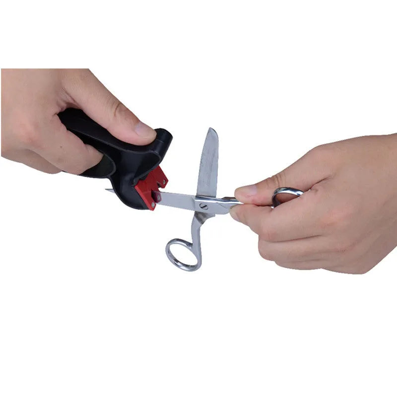 Black handheld knife and scissor sharpener with ergonomic handle on a plain background.