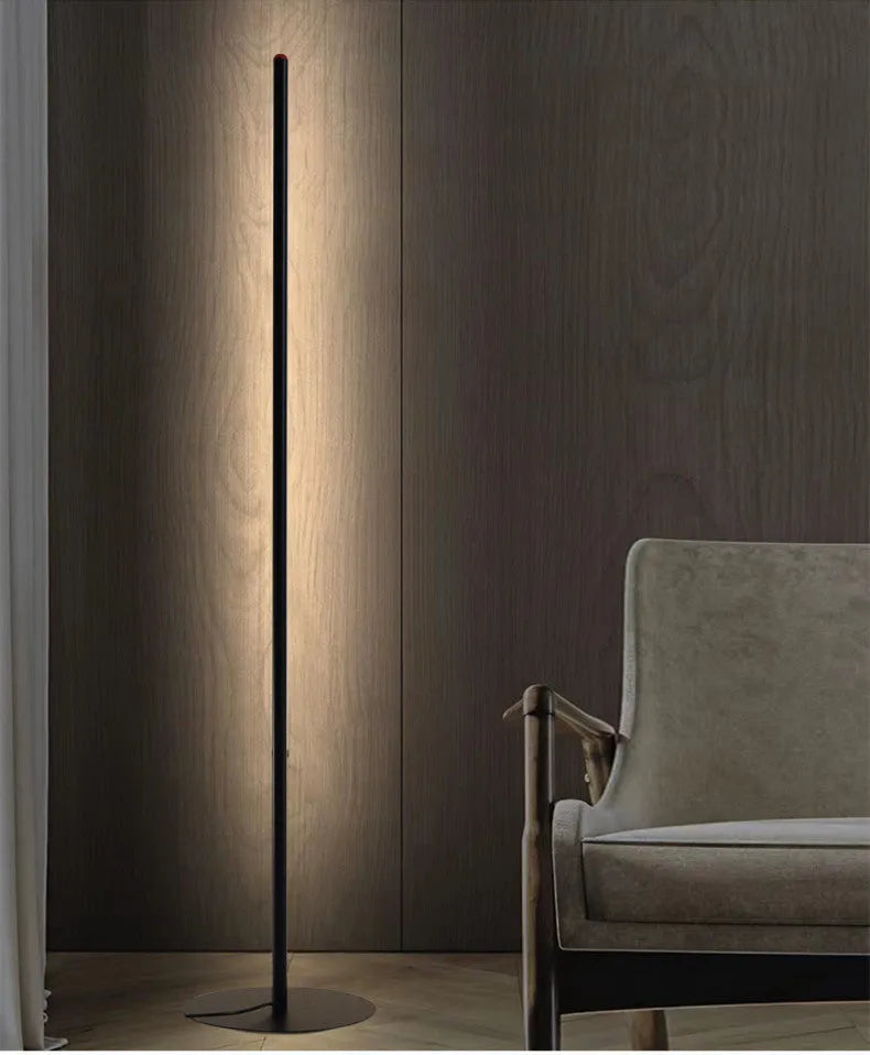 Vertical aluminium alloy floor lamp in modern simple style placed beside a sofa.